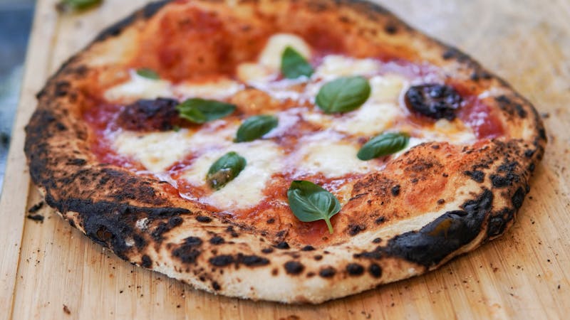 Classic wood-fired Margherita pizza with fresh basil