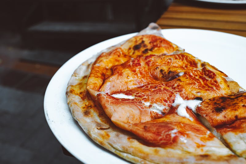 Oven-fresh golden calzone sliced open with filling